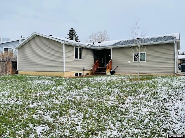 snow covered house with fence and entry steps