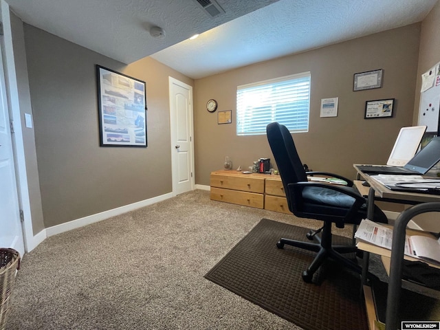 home office featuring visible vents, baseboards, carpet flooring, and a textured ceiling