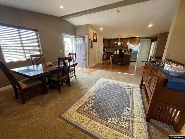 dining room with lofted ceiling with beams, baseboards, recessed lighting, and light colored carpet
