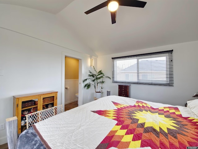 bedroom featuring vaulted ceiling, ensuite bath, and ceiling fan