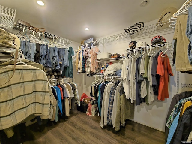 walk in closet with wood finished floors