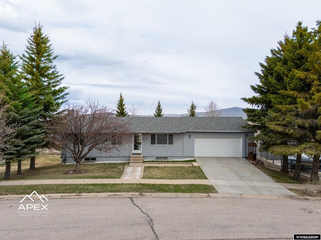 ranch-style home with crawl space, driveway, roof with shingles, and a garage