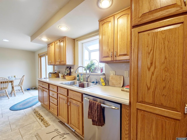 kitchen featuring light countertops, dishwasher, recessed lighting, and a sink