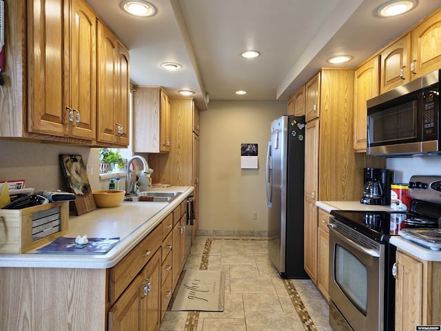 kitchen with stainless steel appliances, a sink, baseboards, recessed lighting, and light countertops