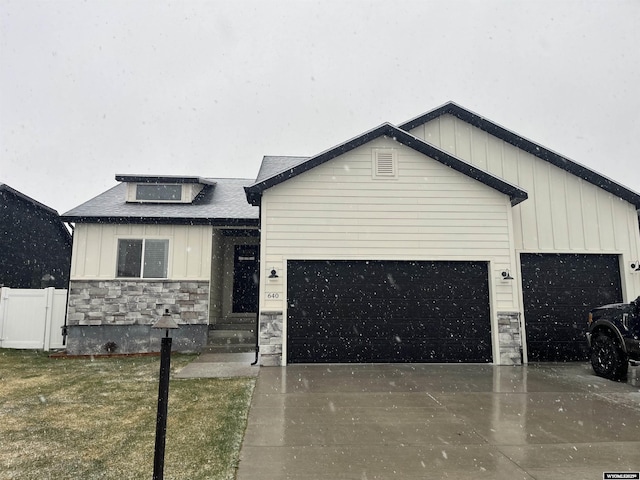 640 Lynn Ct, Green River, WY 82935 - view of front of home featuring stone siding, concrete driveway, board and batten siding, and a garage