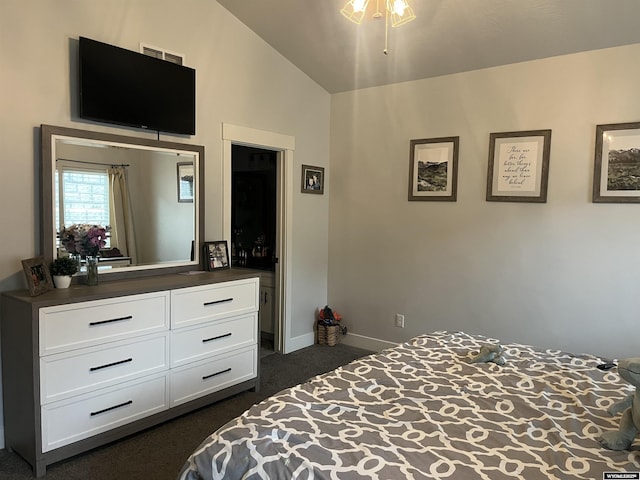 640 Lynn Ct, Green River, WY 82935 - bedroom with vaulted ceiling, dark colored carpet, visible vents, and baseboards