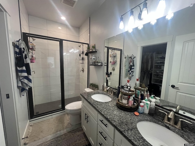 640 Lynn Ct, Green River, WY 82935 - bathroom featuring visible vents, a sink, a shower stall, and toilet