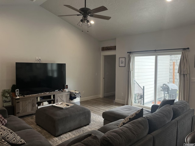 640 Lynn Ct, Green River, WY 82935 - living area with vaulted ceiling, a healthy amount of sunlight, a ceiling fan, and wood finished floors