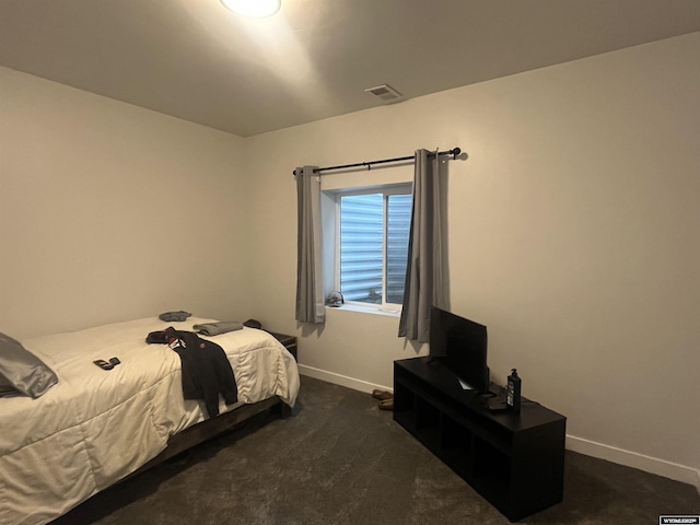 640 Lynn Ct, Green River, WY 82935 - bedroom with baseboards, visible vents, and dark carpet