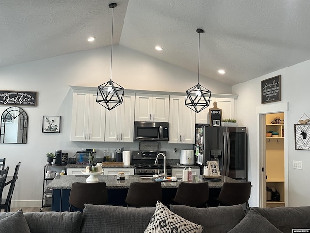 640 Lynn Ct, Green River, WY 82935 - kitchen featuring a kitchen bar, open floor plan, and stainless steel appliances