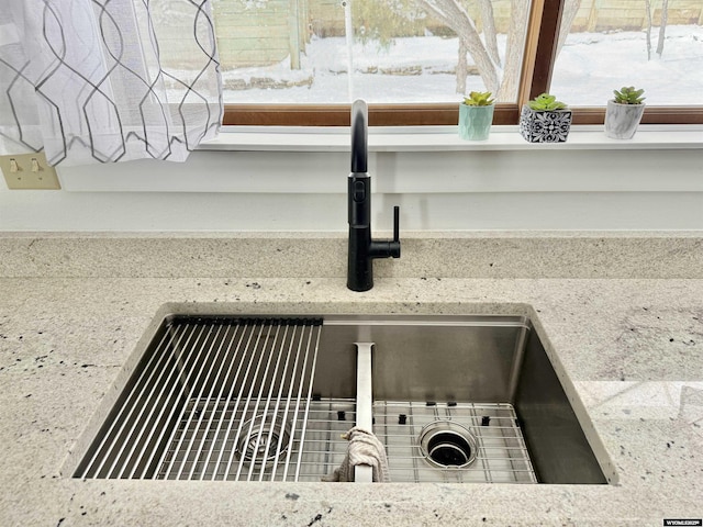 room details featuring stone countertops and a sink