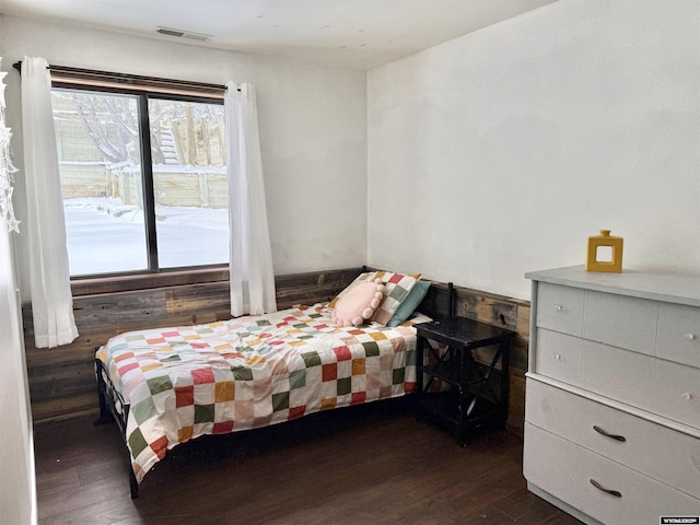 bedroom with dark wood finished floors and visible vents