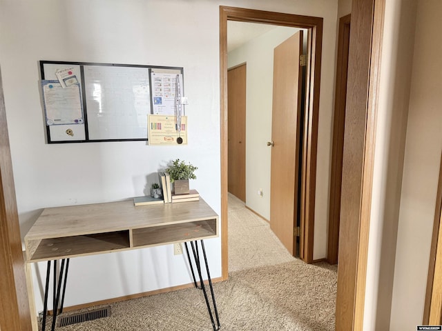 hallway featuring carpet floors and visible vents