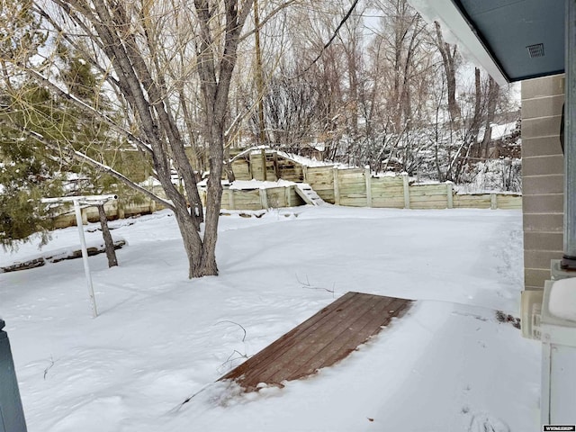 view of yard layered in snow