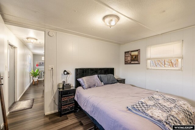 bedroom with dark wood finished floors and a textured ceiling