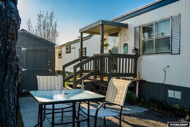 exterior space featuring a storage shed, an outbuilding, and outdoor dining area