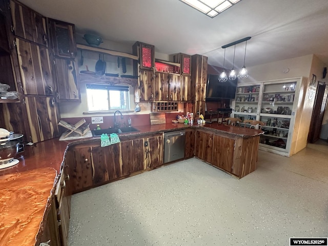 kitchen featuring a peninsula, dishwasher, a sink, and hanging light fixtures