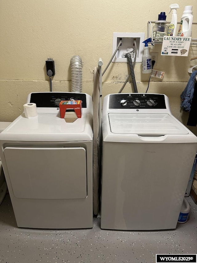 washroom featuring separate washer and dryer and laundry area