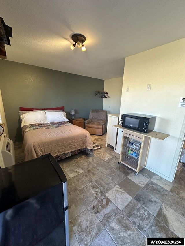 bedroom featuring stone finish floor