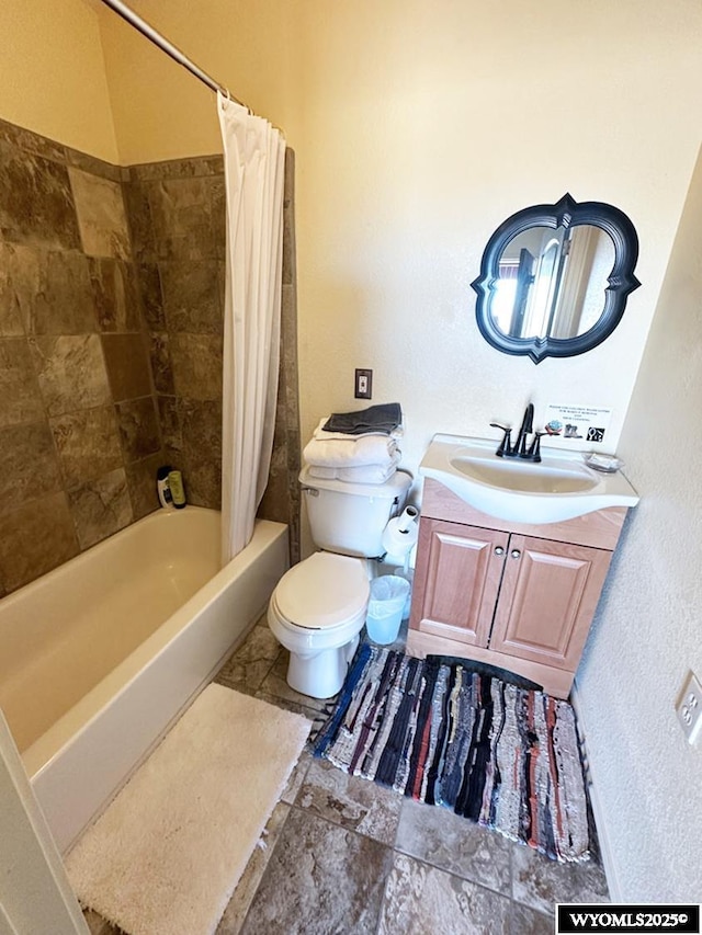 full bathroom with shower / bath combo with shower curtain, toilet, and vanity
