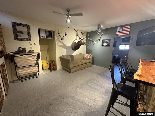 office area with a wall mounted AC, speckled floor, and ceiling fan