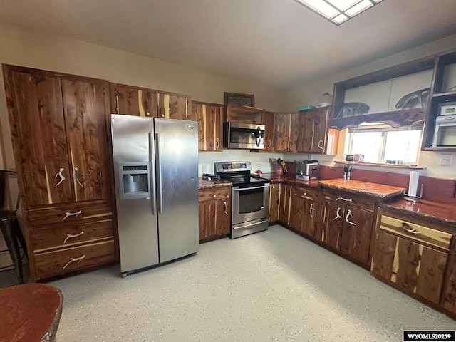 kitchen with open shelves, stainless steel appliances, and dark countertops