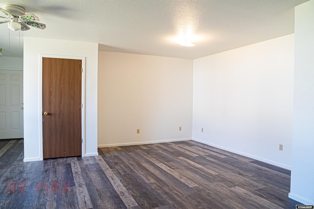 unfurnished room featuring a textured ceiling, a ceiling fan, baseboards, and dark wood-style flooring