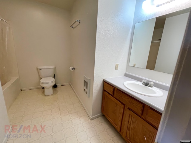 bathroom with tile patterned floors, toilet, vanity, baseboards, and shower / tub combination