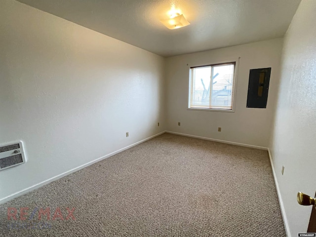 unfurnished room featuring carpet floors, electric panel, and baseboards