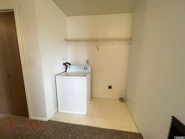 laundry area featuring washer / dryer, baseboards, light floors, and laundry area