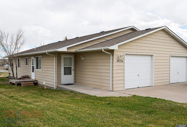 exterior space with an attached garage, a shingled roof, and a front yard