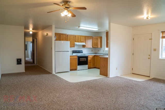 kitchen featuring light carpet, freestanding refrigerator, a ceiling fan, light countertops, and electric stove