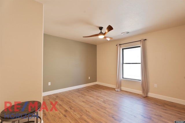 unfurnished room with ceiling fan, baseboards, light wood-style floors, and visible vents