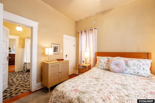 bedroom featuring vaulted ceiling and wood finished floors