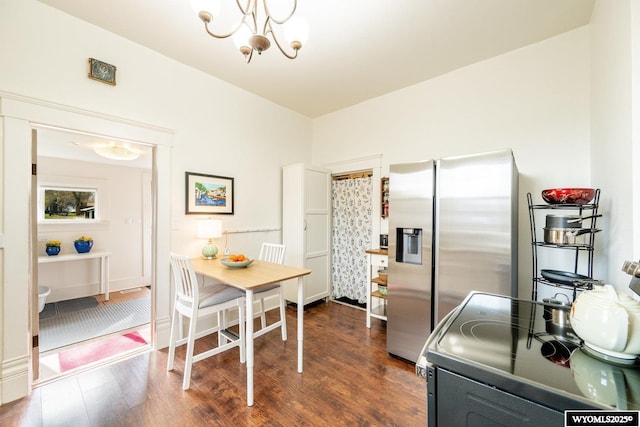 kitchen featuring a chandelier, electric stove, stainless steel refrigerator with ice dispenser, and dark wood-style flooring