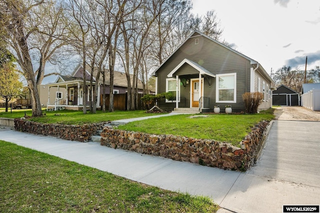 bungalow with fence, a porch, and a front yard