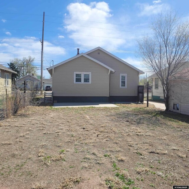 back of house featuring fence