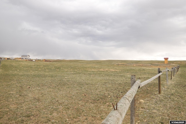 view of yard featuring a rural view and fence