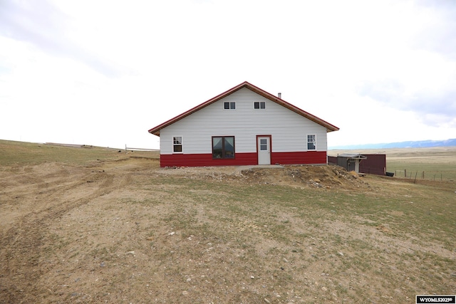 back of house with a rural view
