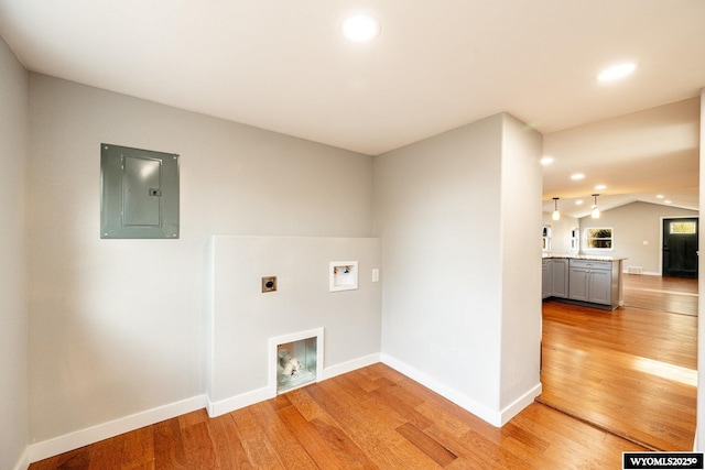 laundry area featuring hookup for an electric dryer, electric panel, washer hookup, and light wood-type flooring