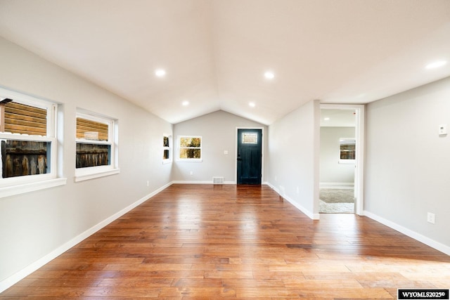 interior space featuring recessed lighting, visible vents, light wood-style flooring, and lofted ceiling