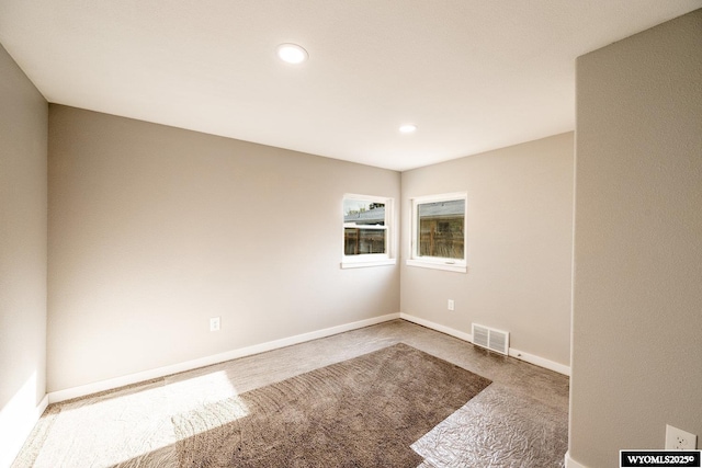 carpeted spare room with visible vents, recessed lighting, and baseboards