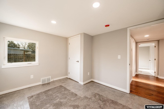 unfurnished bedroom featuring baseboards, visible vents, and recessed lighting