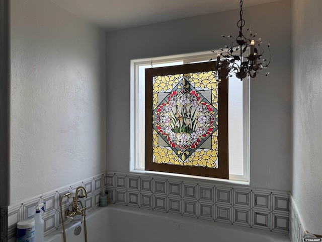 room details with a chandelier and a bath