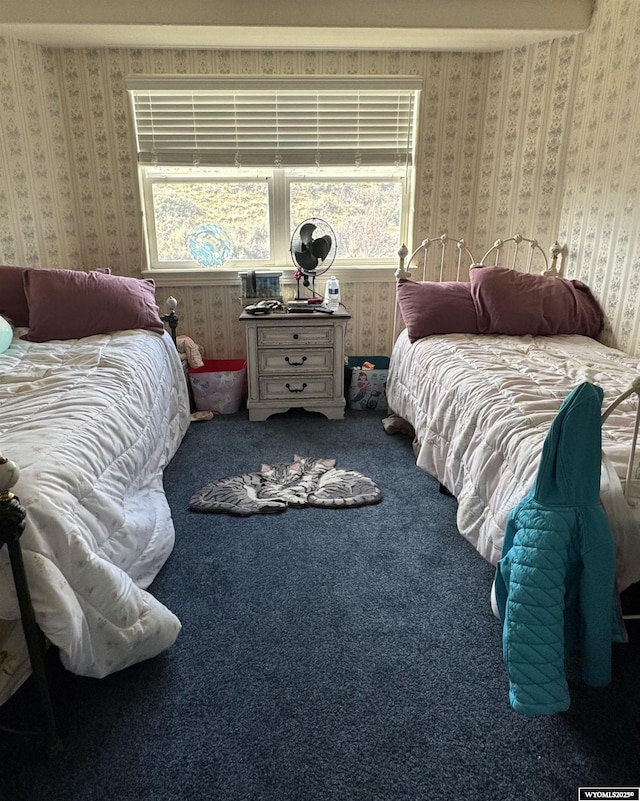 bedroom featuring wallpapered walls and carpet