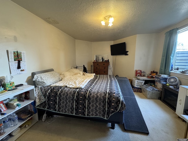 carpeted bedroom with a textured ceiling