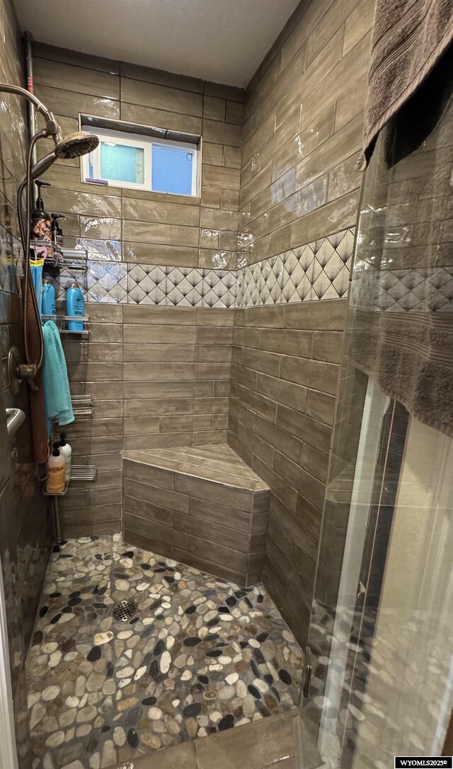 full bath featuring a tile shower