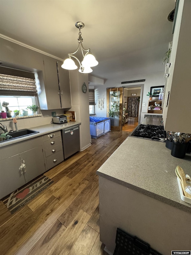 716 B St, Rock Springs, WY 82901 - kitchen featuring stovetop, a sink, dark wood-style flooring, pendant lighting, and dishwasher