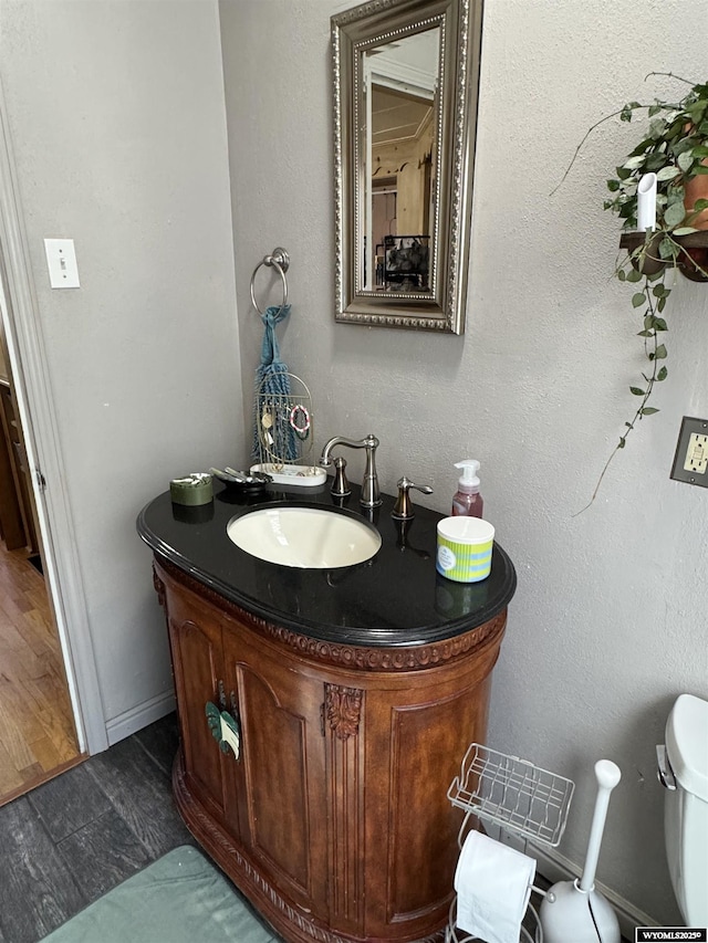 716 B St, Rock Springs, WY 82901 - half bathroom featuring toilet, vanity, and baseboards