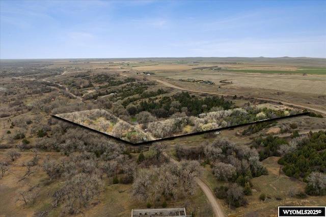 birds eye view of property with a rural view